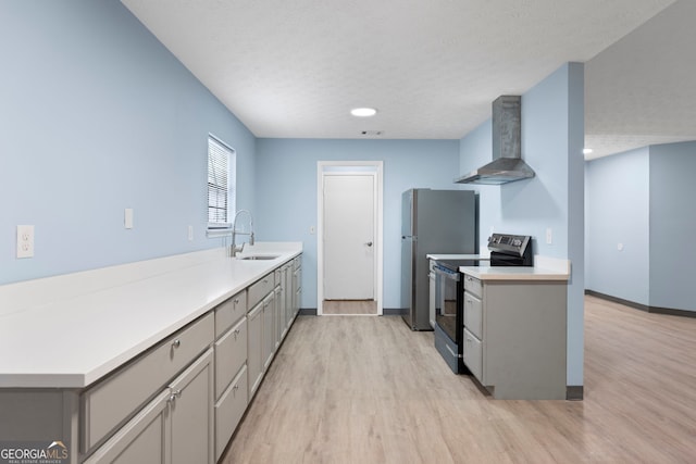 226 Old Atlanta Rd, Stockbridge, GA 30281 - kitchen with wall chimney range hood, electric stove, gray cabinets, light wood-type flooring, and a textured ceiling