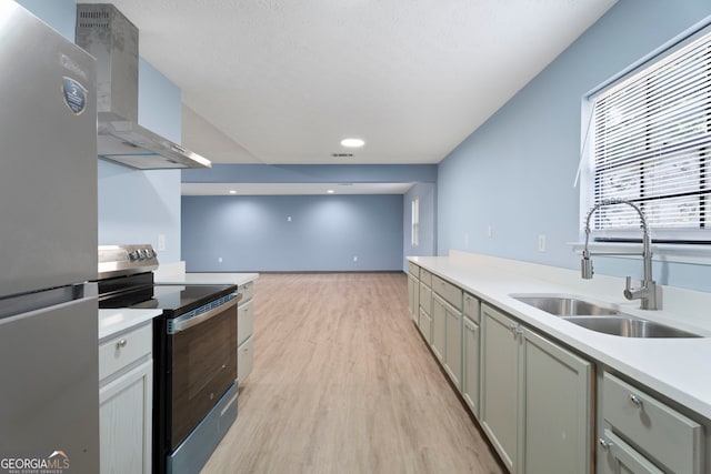 226 Old Atlanta Rd, Stockbridge, GA 30281 - kitchen with appliances with stainless steel finishes, wall chimney range hood, light wood-style flooring, and light countertops