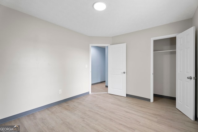 226 Old Atlanta Rd, Stockbridge, GA 30281 - unfurnished bedroom featuring light wood-style flooring and a closet
