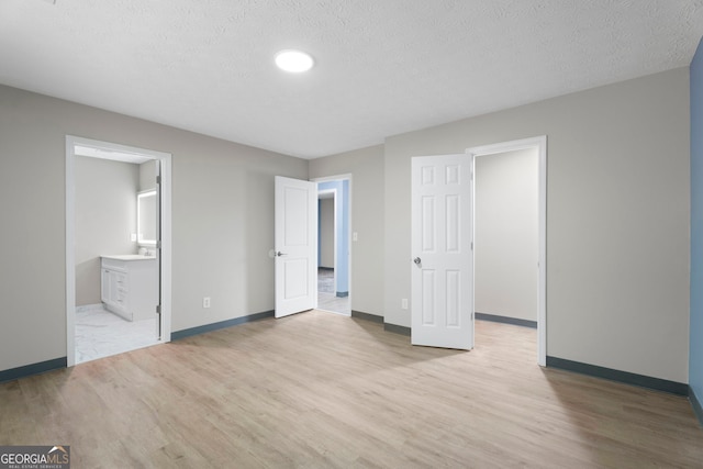 226 Old Atlanta Rd, Stockbridge, GA 30281 - unfurnished bedroom with wood finished floors, a textured ceiling, and ensuite bath