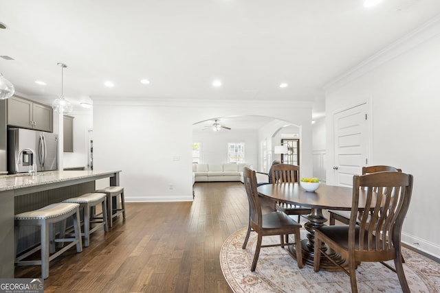 4044 Andover Cir, Mcdonough, GA 30252 - dining area featuring a ceiling fan, arched walkways, dark wood-style flooring, ornamental molding, and recessed lighting