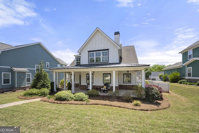 4044 Andover Cir, Mcdonough, GA 30252 - modern inspired farmhouse with board and batten siding, a standing seam roof, a chimney, and a front yard