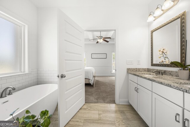 4044 Andover Cir, Mcdonough, GA 30252 - ensuite bathroom with vanity, a soaking tub, and a ceiling fan