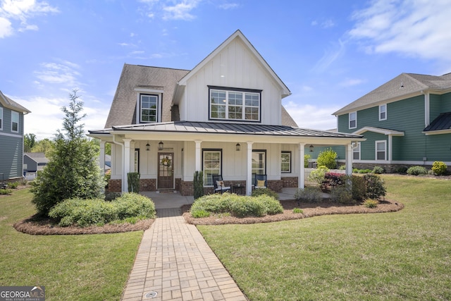 4044 Andover Cir, Mcdonough, GA 30252 - modern farmhouse with board and batten siding, brick siding, a porch, and a standing seam roof