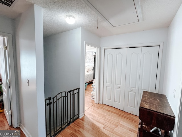 105 Sheffield Dr, Carrollton, GA 30117 - hall with attic access, light wood-style flooring, and an upstairs landing