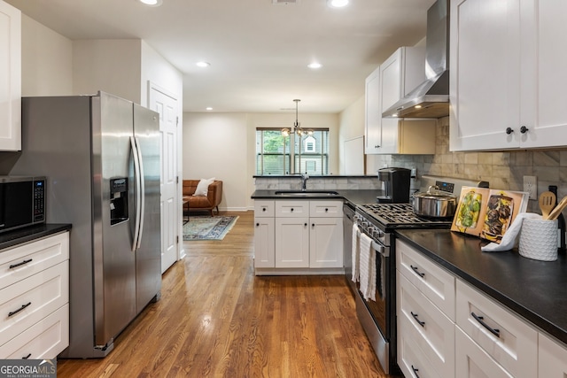 429 Deckner Ave SW, Atlanta, GA 30310 - kitchen with stainless steel appliances, a sink, wall chimney exhaust hood, dark countertops, and a peninsula