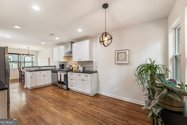429 Deckner Ave SW, Atlanta, GA 30310 - kitchen with stainless steel appliances, wall chimney range hood, a peninsula, a sink, and dark countertops