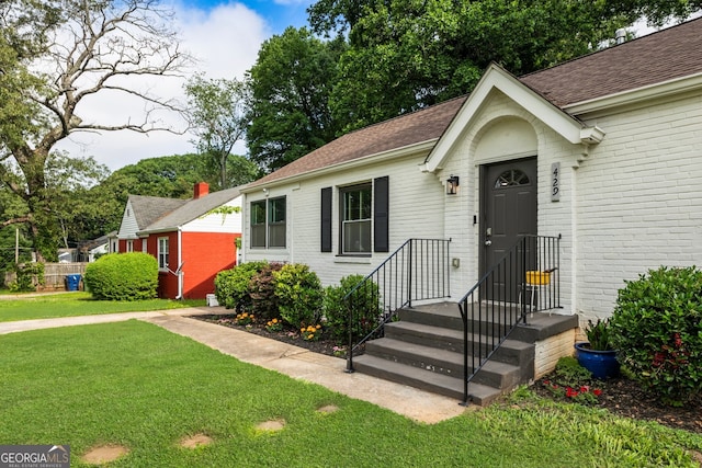 429 Deckner Ave SW, Atlanta, GA 30310 - view of front of home with a front lawn, brick siding, and roof with shingles