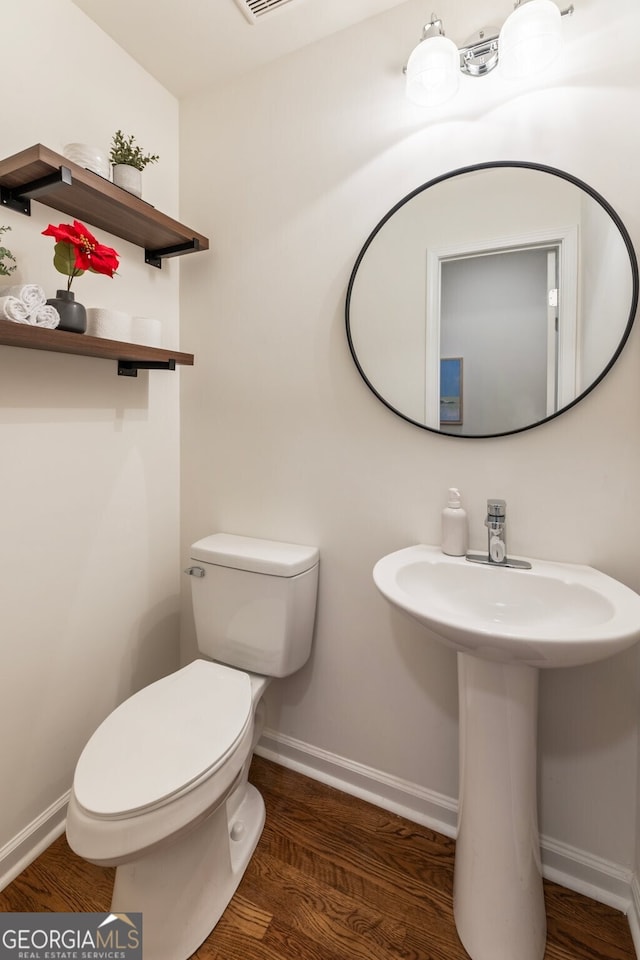 429 Deckner Ave SW, Atlanta, GA 30310 - bathroom featuring toilet, baseboards, and wood finished floors