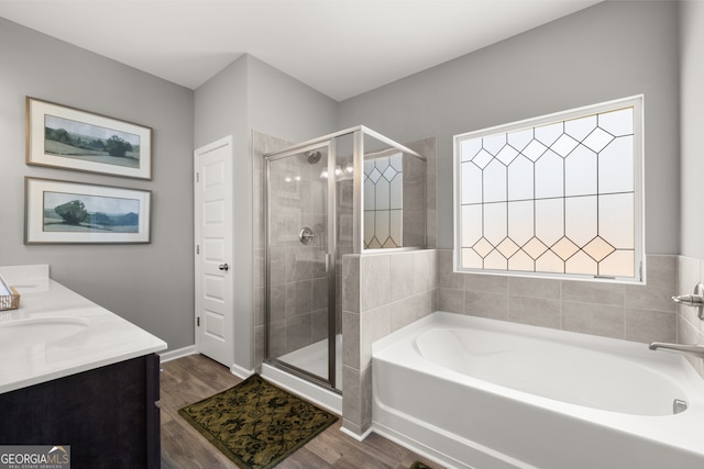 237 Orion Dr, Dalton, GA 30720 - bathroom featuring a garden tub, a shower stall, wood finished floors, and double vanity