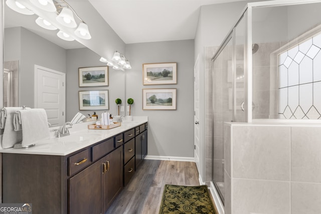237 Orion Dr, Dalton, GA 30720 - bathroom featuring double vanity, a stall shower, wood finished floors, and baseboards
