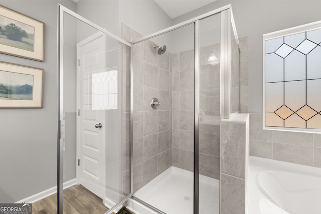 237 Orion Dr, Dalton, GA 30720 - bathroom featuring a stall shower, a bath, and wood finished floors