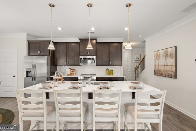 237 Orion Dr, Dalton, GA 30720 - kitchen with stainless steel appliances, dark wood-type flooring, decorative backsplash, dark brown cabinetry, and ornamental molding