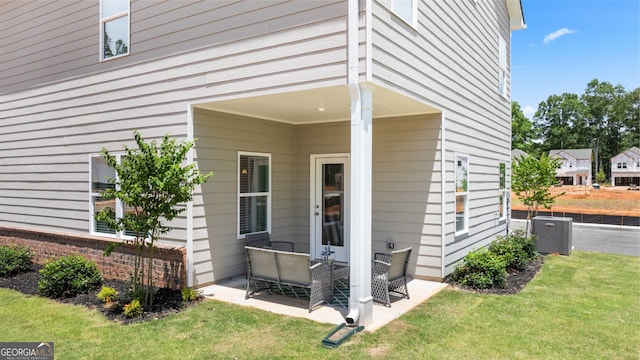 237 Orion Dr, Dalton, GA 30720 - property entrance featuring a patio area, central air condition unit, and a lawn