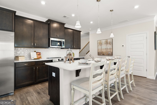 237 Orion Dr, Dalton, GA 30720 - kitchen with stainless steel appliances, ornamental molding, wood finished floors, light countertops, and backsplash