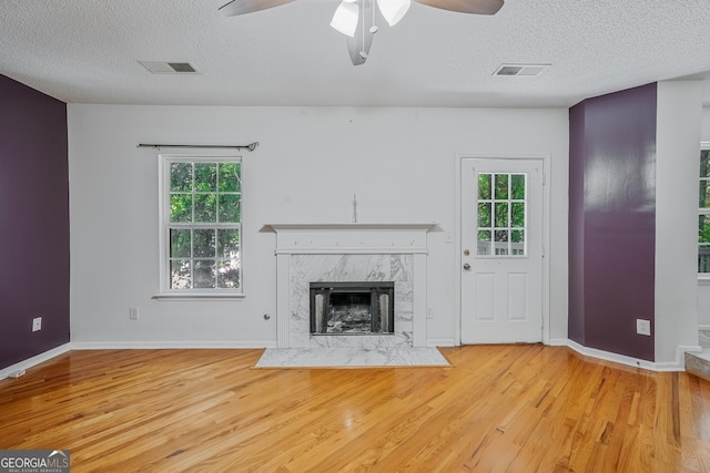 3524 Forest Downs Cv, Decatur, GA 30034 - unfurnished living room with a textured ceiling, wood finished floors, ceiling fan, and healthy amount of natural light