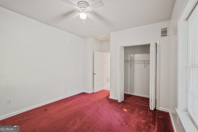 3524 Forest Downs Cv, Decatur, GA 30034 - unfurnished bedroom with dark colored carpet, a textured ceiling, a closet, baseboards, and ceiling fan