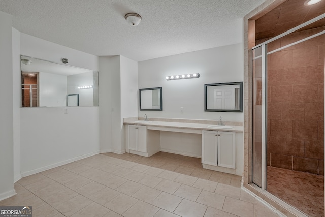 3524 Forest Downs Cv, Decatur, GA 30034 - bathroom with a shower stall, double vanity, tile patterned floors, a textured ceiling, and baseboards