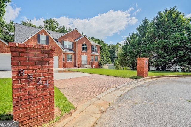 3524 Forest Downs Cv, Decatur, GA 30034 - view of front facade with driveway, brick siding, a front lawn, and a garage