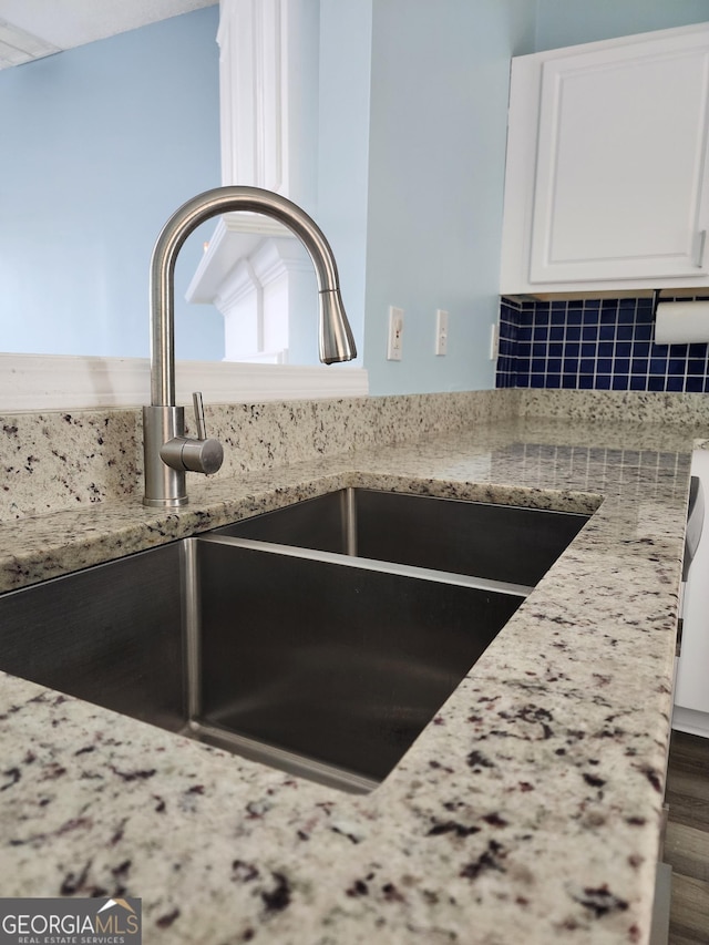10900 Wittenridge Dr Unit H8, Alpharetta, GA 30022 - kitchen view of a sink, white cabinetry, light stone countertops, and decorative backsplash