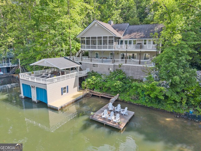 1431 Tame Turkey Rd, Lakemont, GA 30552 - back of property featuring stairway, a deck with water view, a wooded view, a sunroom, and a chimney