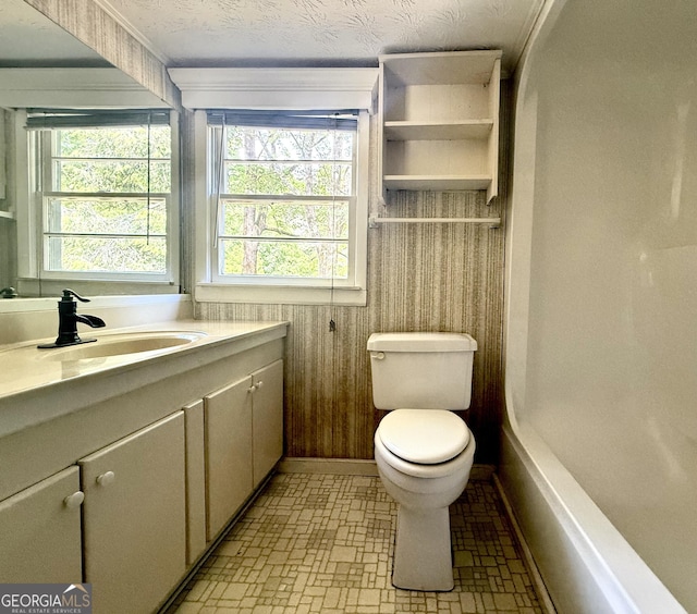 4850 New Liberty Rd, Clarkesville, GA 30523 - bathroom with vanity, toilet, baseboards, brick patterned floors, and shower / tub combination