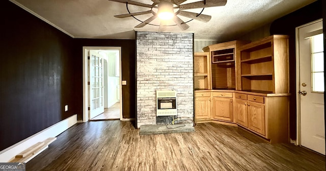 4850 New Liberty Rd, Clarkesville, GA 30523 - unfurnished living room with heating unit, a ceiling fan, dark wood-type flooring, a textured ceiling, and ornamental molding