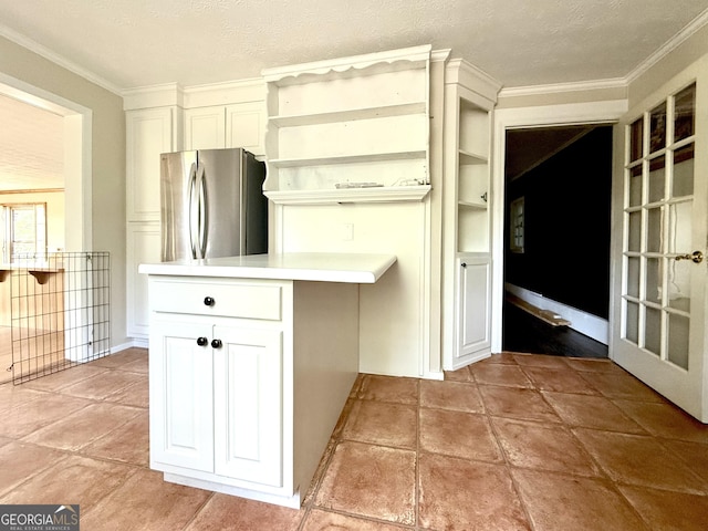 4850 New Liberty Rd, Clarkesville, GA 30523 - kitchen with freestanding refrigerator, open shelves, crown molding, light countertops, and white cabinetry