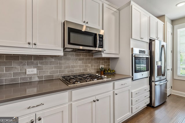 123 Mulberry Ct, Peachtree City, GA 30269 - kitchen with appliances with stainless steel finishes, dark wood finished floors, decorative backsplash, and healthy amount of natural light