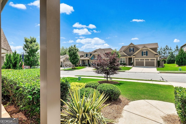 123 Mulberry Ct, Peachtree City, GA 30269 - view of green lawn featuring driveway, a garage, and a residential view