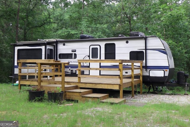 LT.544 Beechwood Ln SW Unit 544, Sparta, GA 31087 - back of property with a wooden deck and a forest view