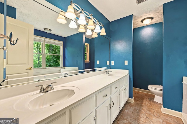 299 Fieldview Dr, Auburn, GA 30011 - bathroom with baseboards, double vanity, toilet, and stone finish flooring