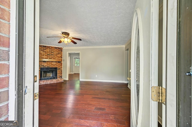 299 Fieldview Dr, Auburn, GA 30011 - unfurnished living room featuring hardwood / wood-style flooring, a ceiling fan, crown molding, baseboards, and a textured ceiling