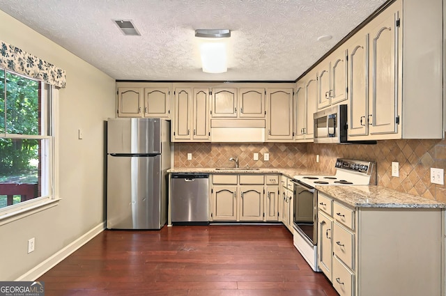 299 Fieldview Dr, Auburn, GA 30011 - kitchen with stainless steel appliances, dark wood-style flooring, a textured ceiling, baseboards, and a sink