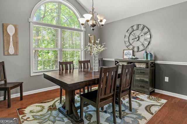 230 Hannah Dr, Colbert, GA 30628 - dining area with a chandelier, wood finished floors, lofted ceiling, and baseboards
