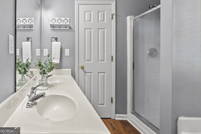 230 Hannah Dr, Colbert, GA 30628 - bathroom featuring a stall shower, double vanity, and wood finished floors