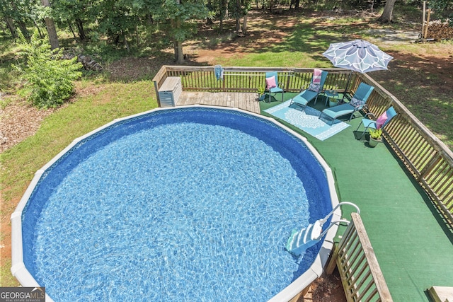 230 Hannah Dr, Colbert, GA 30628 - view of swimming pool featuring a wooden deck and view of wooded area