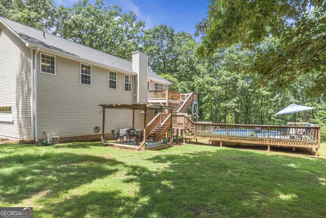 230 Hannah Dr, Colbert, GA 30628 - rear view of property featuring a deck, a chimney, a lawn, and stairs