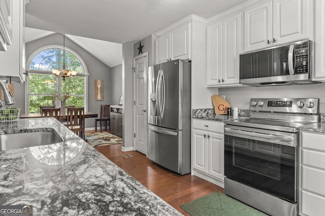 230 Hannah Dr, Colbert, GA 30628 - kitchen featuring appliances with stainless steel finishes, dark wood-style flooring, a chandelier, a sink, and white cabinets