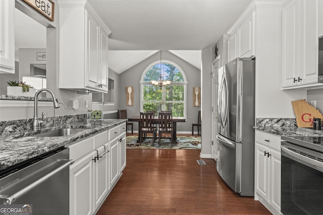 230 Hannah Dr, Colbert, GA 30628 - kitchen featuring appliances with stainless steel finishes, a sink, white cabinetry, lofted ceiling, and a textured ceiling