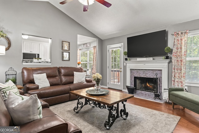 230 Hannah Dr, Colbert, GA 30628 - living area featuring wood finished floors, ceiling fan, a brick fireplace, and high vaulted ceiling