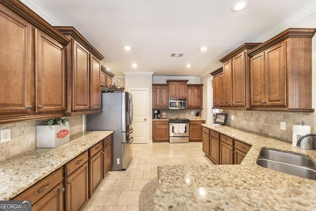 215 Wilsons Creek Bnd, Bonaire, GA 31005 - kitchen with appliances with stainless steel finishes, a sink, crown molding, decorative backsplash, and light stone countertops