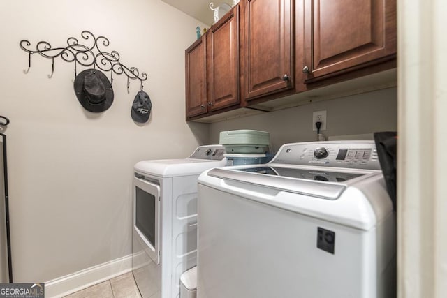 215 Wilsons Creek Bnd, Bonaire, GA 31005 - laundry area featuring independent washer and dryer, light tile patterned floors, cabinet space, and baseboards