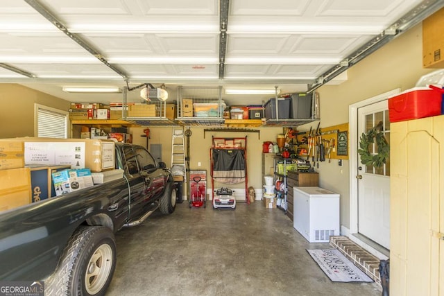 215 Wilsons Creek Bnd, Bonaire, GA 31005 - garage with fridge and a garage door opener