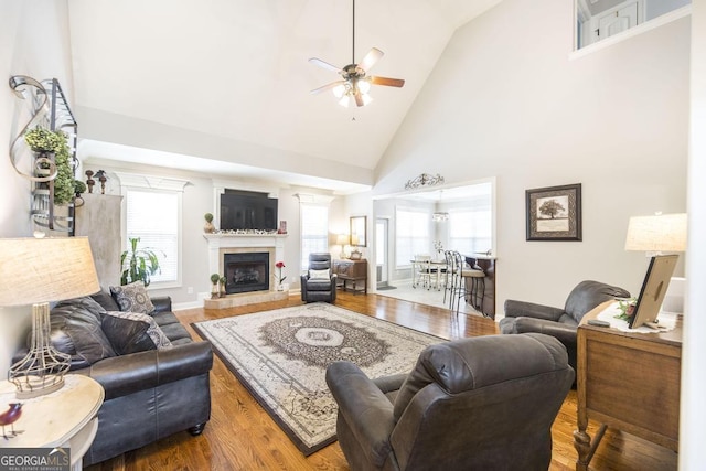 215 Wilsons Creek Bnd, Bonaire, GA 31005 - living area with a ceiling fan, high vaulted ceiling, wood finished floors, and a fireplace with raised hearth