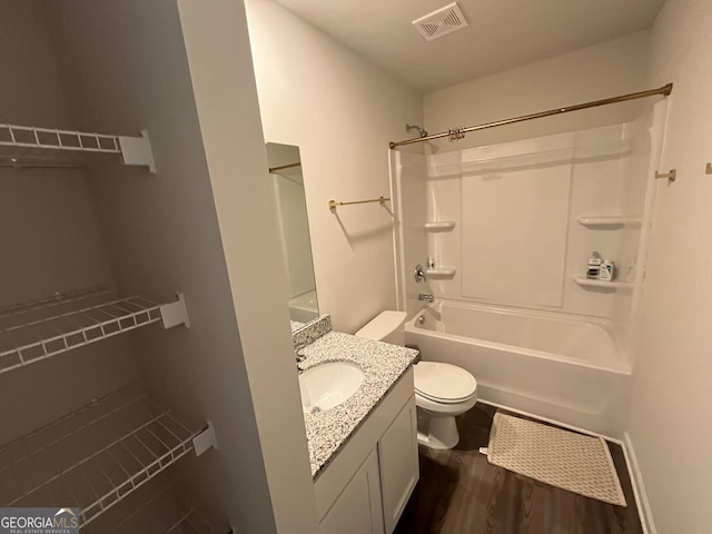134 Red Oak Dr, Barnesville, GA 30204 - full bath with vanity, toilet,  shower combination, and wood finished floors