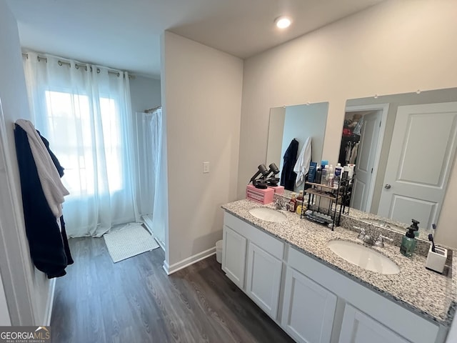 134 Red Oak Dr, Barnesville, GA 30204 - full bath with wood finished floors, double vanity, a shower with curtain, and baseboards