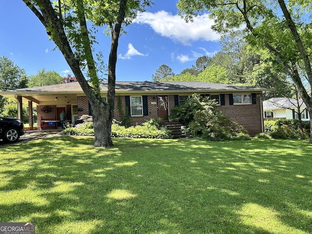2334 Connally Dr, East Point, GA 30344 - ranch-style house with brick siding, a front yard, and a carport