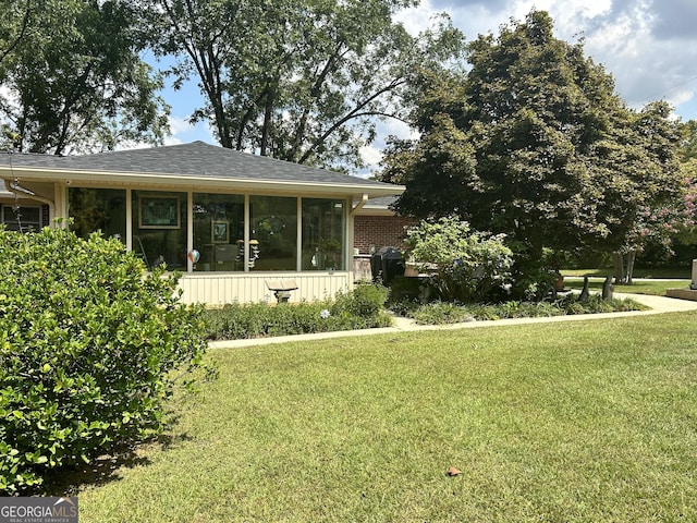 2334 Connally Dr, East Point, GA 30344 - view of property exterior with a sunroom and a lawn
