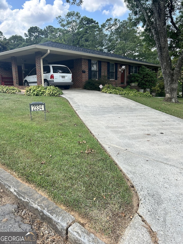 2334 Connally Dr, East Point, GA 30344 - single story home featuring brick siding, concrete driveway, a front yard, and an attached carport